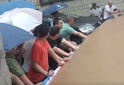 车主牺牲自己堵住洪水进入车库为车库移出300多台车争取了宝贵时间