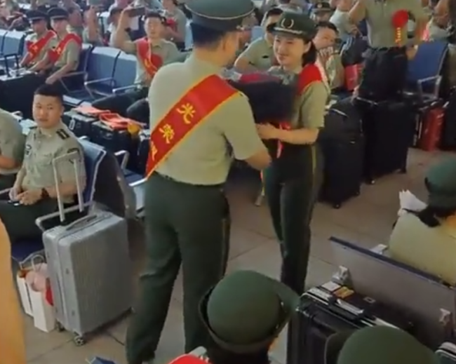 退伍兵向女战友求婚 怀抱鲜花拿戒指 周围战友们连连起哄