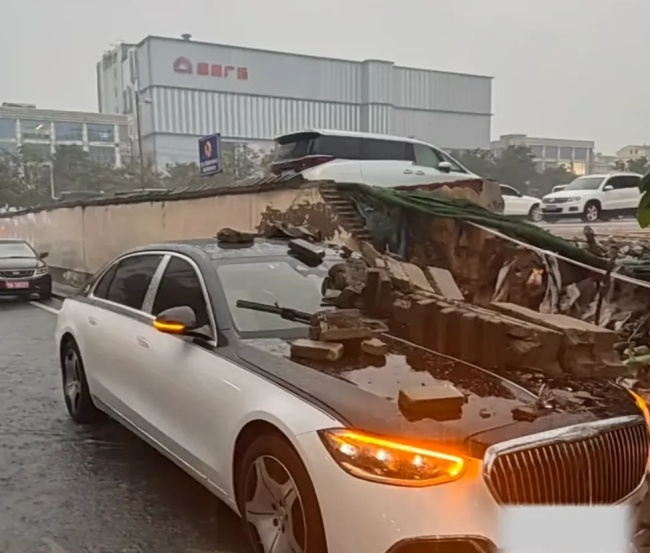 河南一停车场围墙倒塌 砸中迈巴赫
